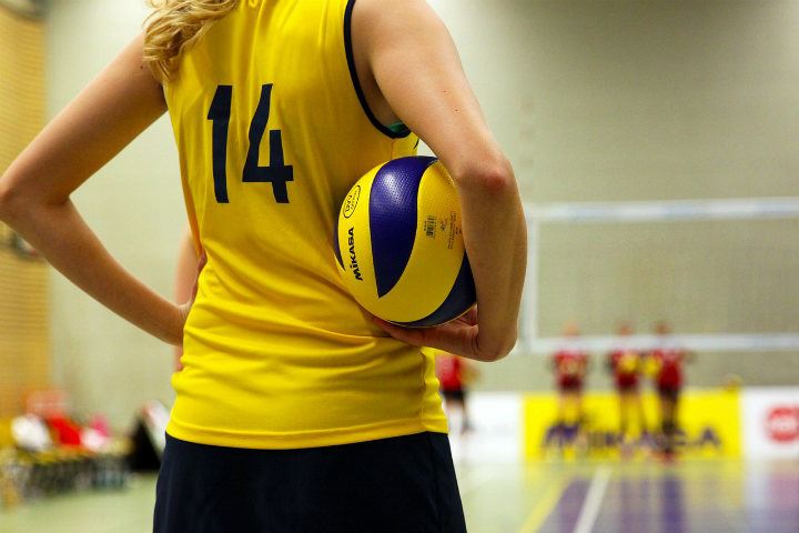 volleyball girl in yellow shirt holding ball