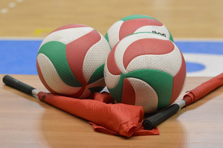 volleyballs and flags on the court