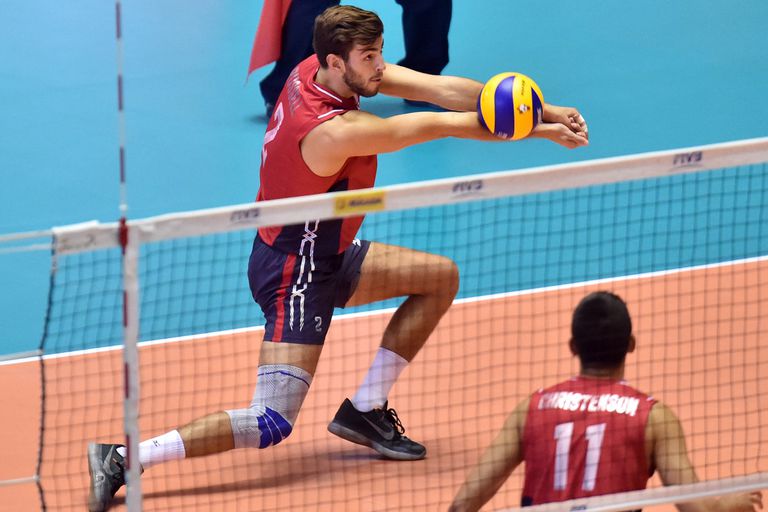 player bumps a volleyball in game