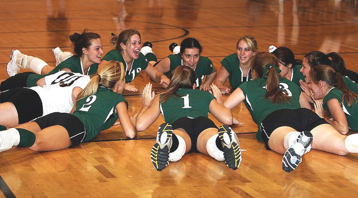 girls volleyball team on the floor