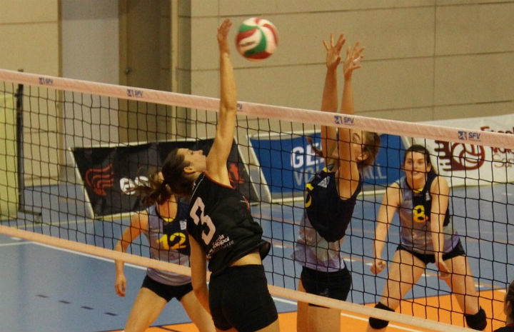 girl spiking volleyball during game